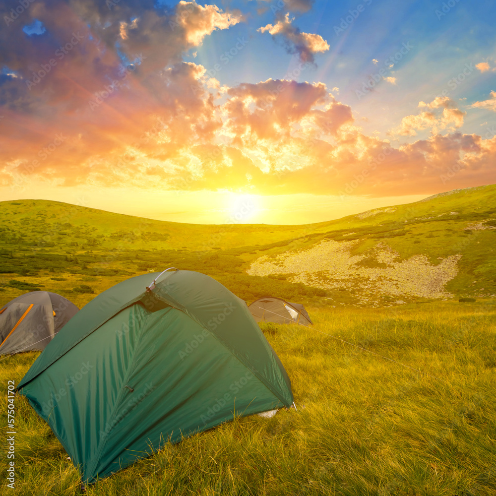 touristic tent among green hills at the sunset, mountain travel scene