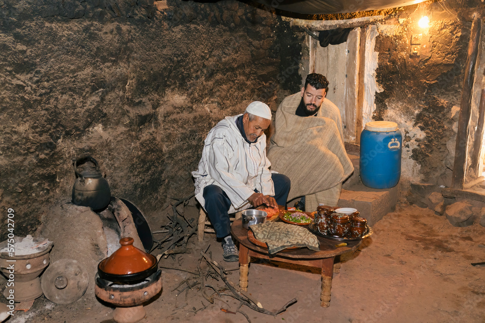 Fotomural A father and son berber preparing food together to cook in a timeless traditiona