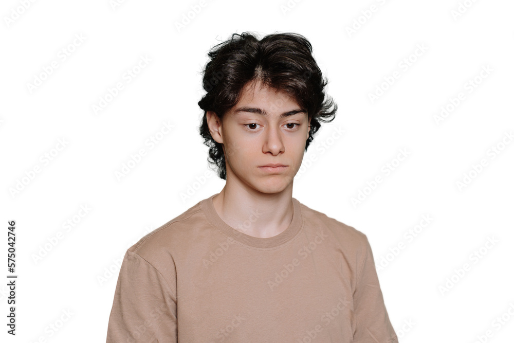 Upset handsome schoolboy tired looks down standing against transparent