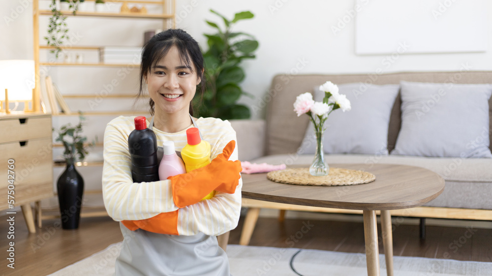 Asian housewife wearing apron and gloves holding toilet cleaner preparing to clean the bathroom, Housework, Daily routine, Big cleaning, Clean and remove germs and dirt, Clean up on weekends. Asian housewife wearing apron and gloves holding toilet cleaner preparing to clean the bathroom, Housework, Daily routine, Big cleaning, Clean and remove germs and dirt, Clean up on weekends.