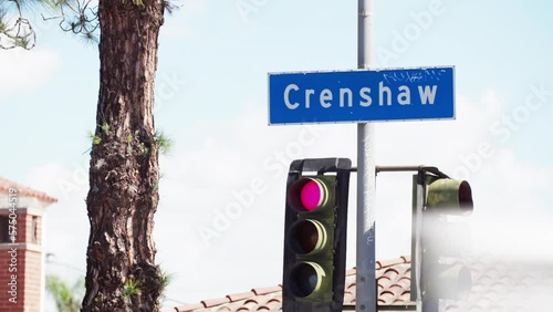 Tilt Up To A Crenshaw Street Sign With A Red Traffic Light  - Los Angeles, California photo