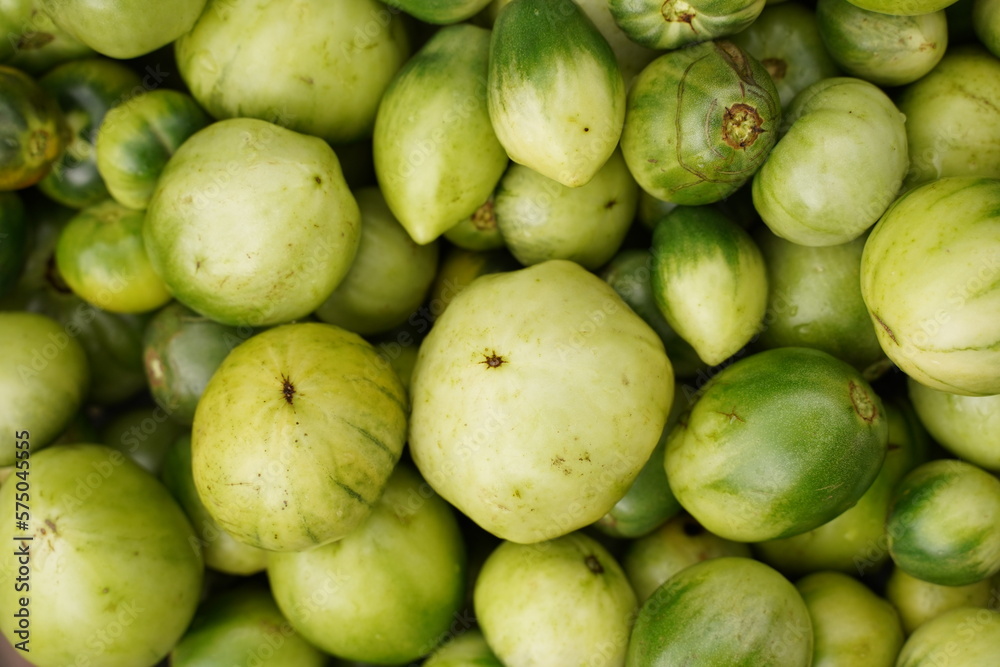 Green unripe tomatoes background. Top view Green unripe tomatoes background. Top view