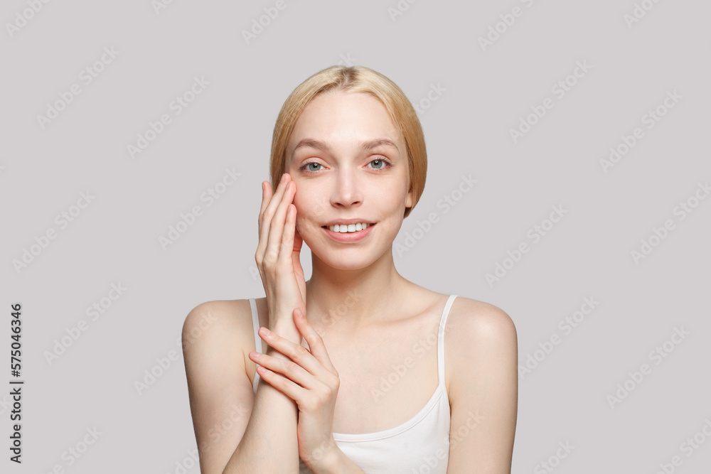 Portrait of happy gorgeous woman with clean skin isolated on grey background. Beauty, cosmetics, skincare, glamour Portrait of happy gorgeous woman with clean skin isolated on grey background. Beauty, cosmetics, skincare, glamour