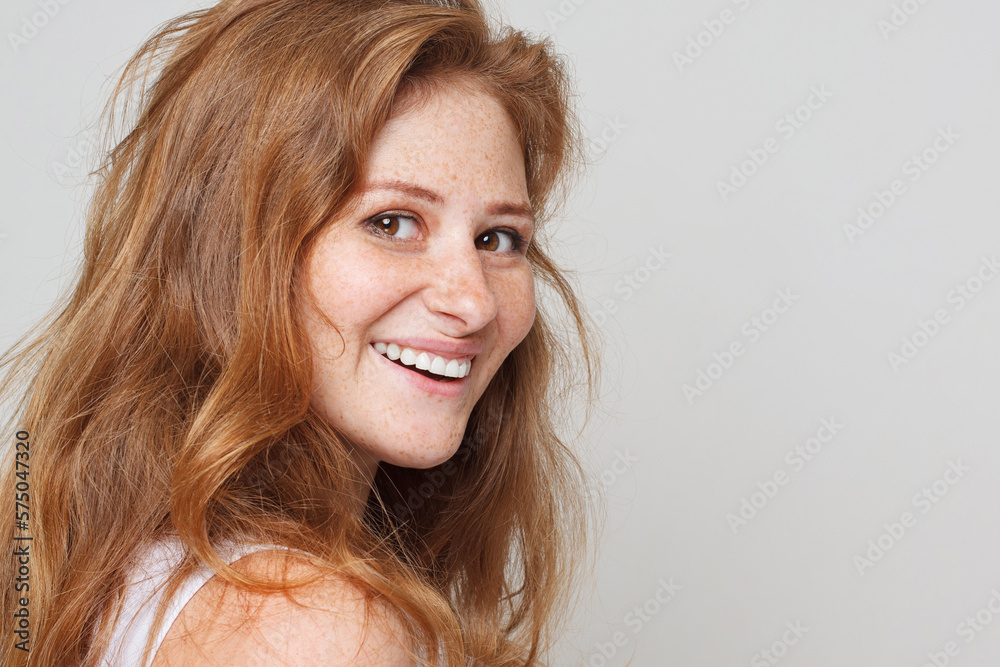 Female beauty. Close-up of young beautiful redhead woman smiling at camera on white background Female beauty. Close-up of young beautiful redhead woman smiling at camera on white background
