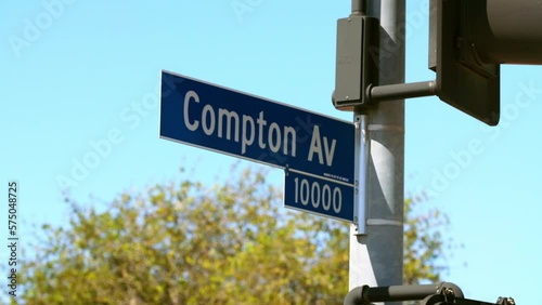 Lockdown Of A Blue Compton Street Sign Against A Bright Blue Sky  - Los Angeles, California photo