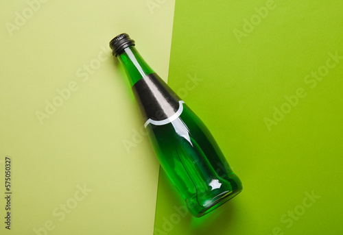 Bottle of green Irish beer on a green background. Top view