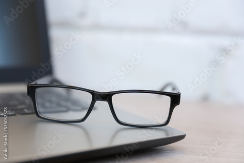 Closeup of eyeglasses with a laptop. Business concept, vision correction