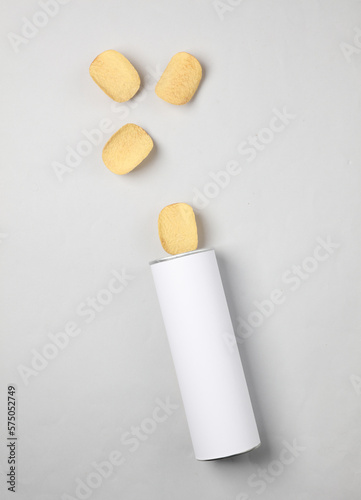 White tube of potato chips on a gray background. Mock up for template design. Space for text
