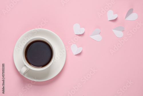 Cup of tea or coffee with hearts on a pink background. Top view