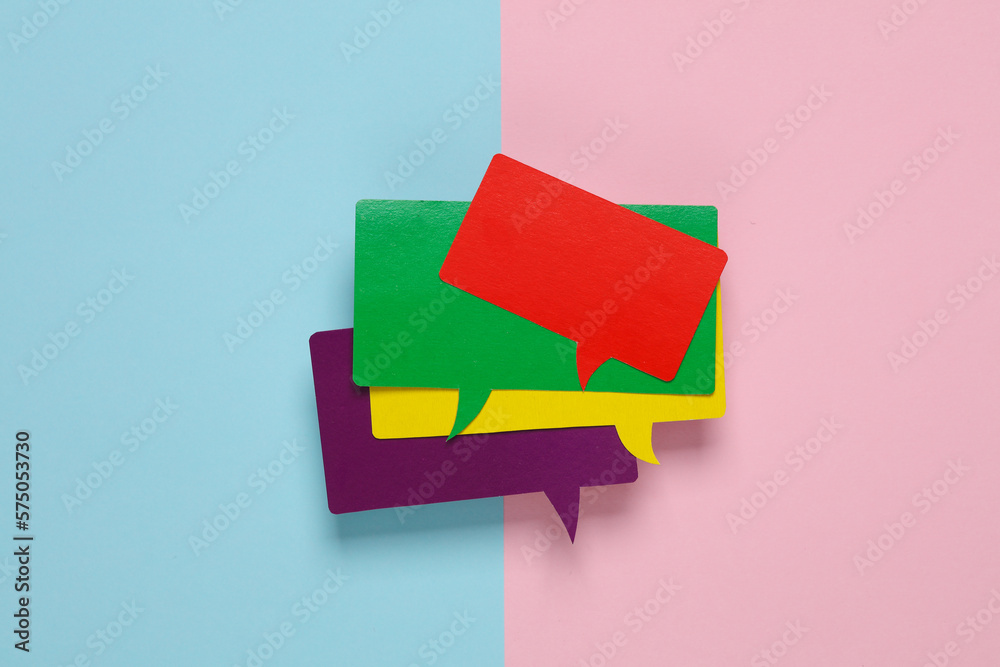 Фотография Different colors stack of blank paper-cut speech bubbles on pink blue background