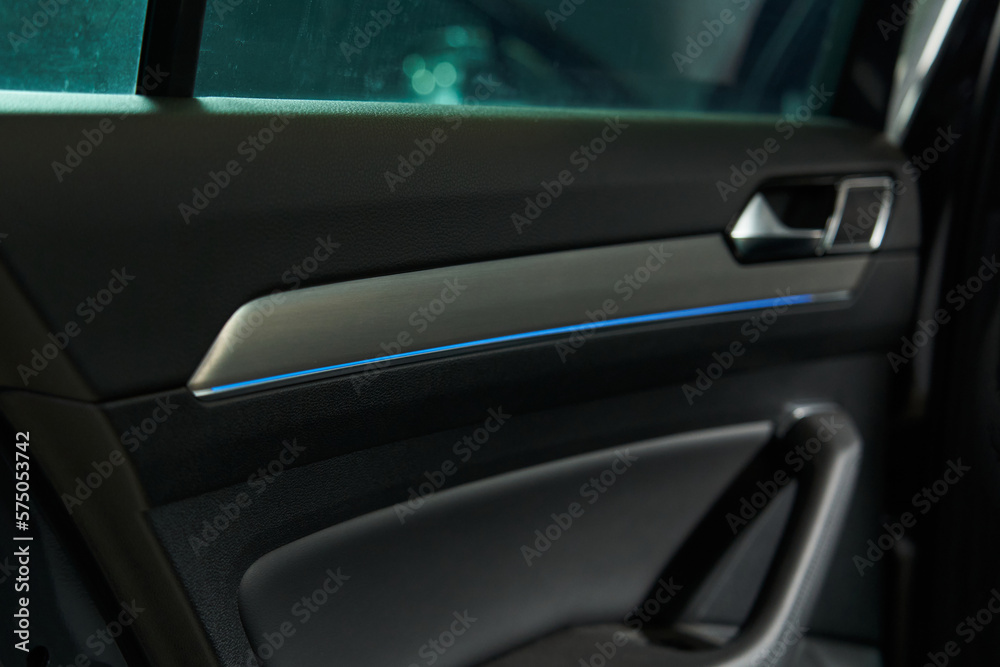 car interior trim with handle for opening and closing the door and blue LED strip