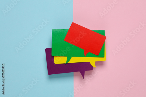 Valokuva Different colors stack of blank paper-cut speech bubbles on pink blue background