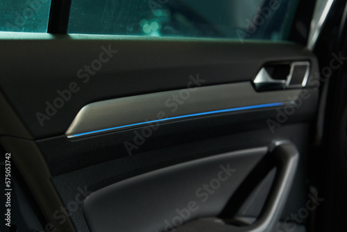 car interior trim with handle for opening and closing the door and blue LED strip © Elena