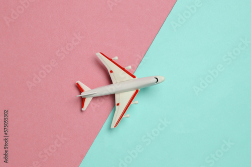 Toy passenger plane on a blue pink background. Voyage, Travel concept. Top view