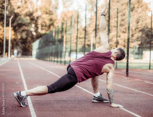 Athletic muscular man warming up before training at the stadium. Healthy lifestyle © splitov27