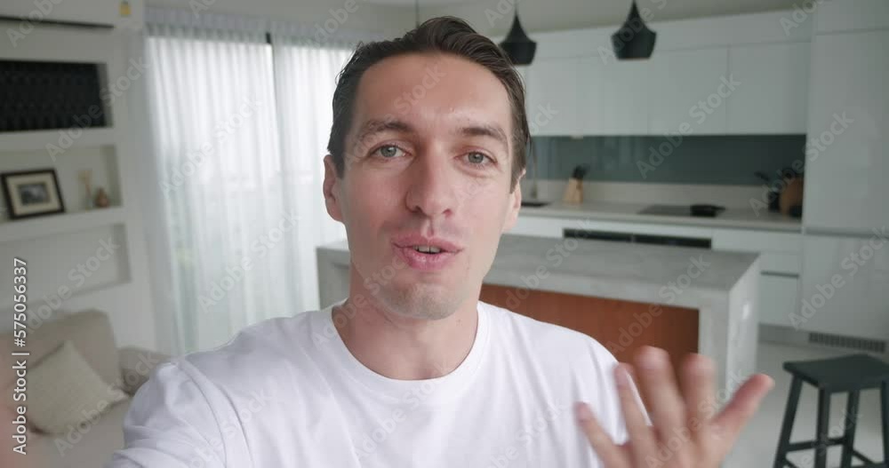 Point of view millennial man excited face live steam at home interior. Selfie view young man holding using smartphone take video call on modern interior. Blogger doing video chat from his apartment. Point of view millennial man excited face live steam at home interior. Selfie view young man holding using smartphone take video call on modern interior. Blogger doing video chat from his apartment.
