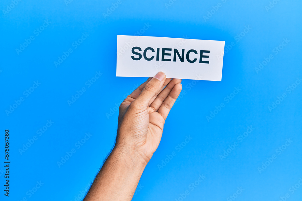 Hand of caucasian man holding paper with science word over isolated blue background Hand of caucasian man holding paper with science word over isolated blue background