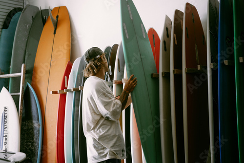 Man choosing a surfboard in a surfboard shop