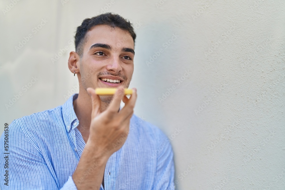 Young hispanic man smiling confident talking on the smartphone over white isolated background Young hispanic man smiling confident talking on the smartphone over white isolated background