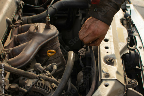 mechanic repairs car engine, hand of master