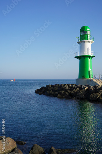 The small green lighthouse in Warnemünde at the harbour entrance of Rostock 