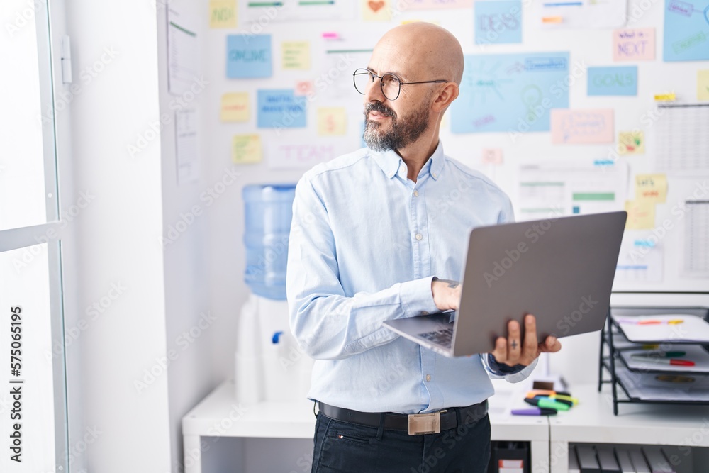 Young bald man business worker using laptop working at office Young bald man business worker using laptop working at office