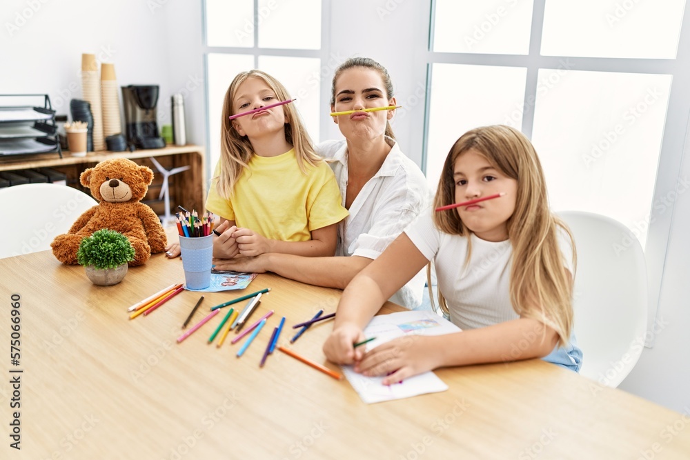 Mother and daughters with funny expression drawing at home Mother and daughters with funny expression drawing at home