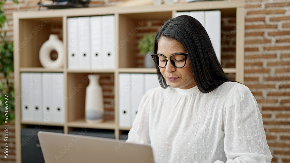 Young beautiful latin woman business worker using laptop working at office Young beautiful latin woman business worker using laptop working at office