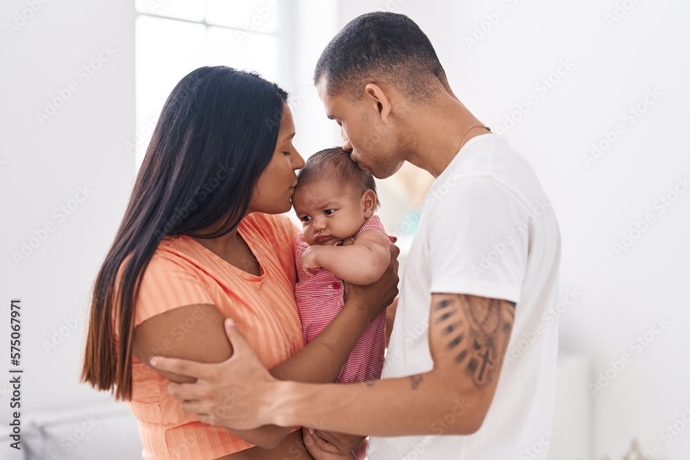 Hispanic family hugging each other kissing at home