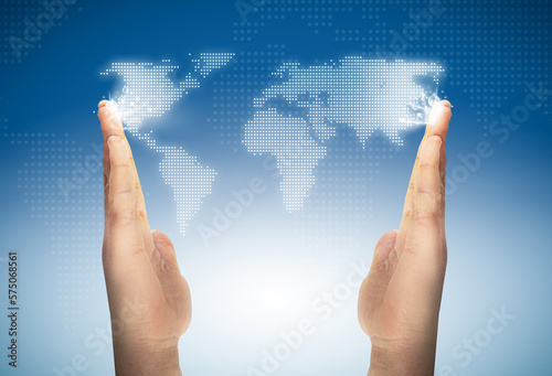 dotted world map among the hands over a blue background