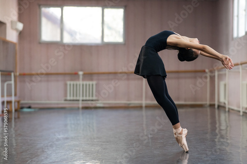Asian woman dancing in ballet class. Bending in the back. © Михаил Решетников