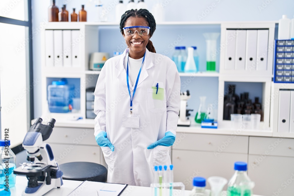 African american woman scientist smiling confident standing at laboratory