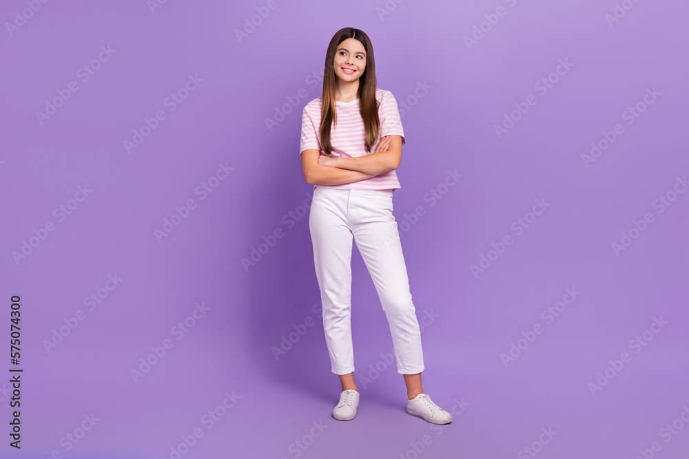 Full body photo of cheerful minded person crossed hands look interested empty space isolated on violet color background Full body photo of cheerful minded person crossed hands look interested empty space isolated on violet color background