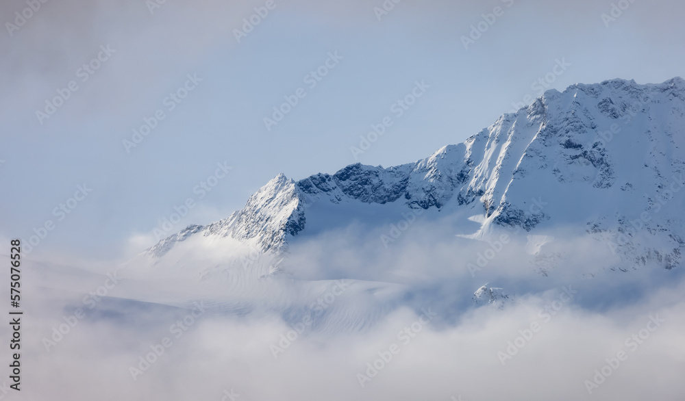 Tantalus Range covered in Snow and Clouds during Winter Season. Near Whistler and Squamish, British Columbia, Canada. Nature Background