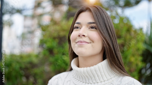 Young beautiful hispanic woman smiling confident looking to the sky at park