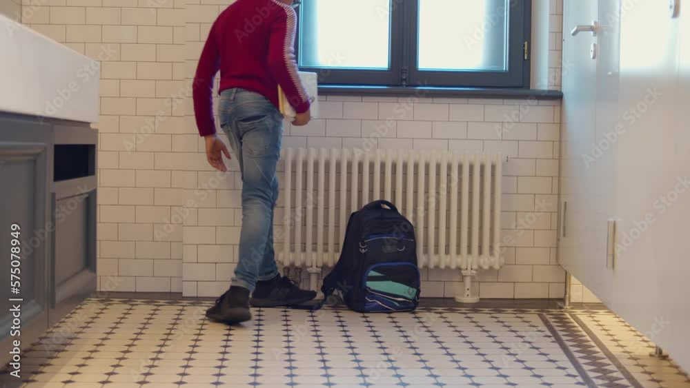 Sad African-American schoolboy sitting on toilet floor of school and ...