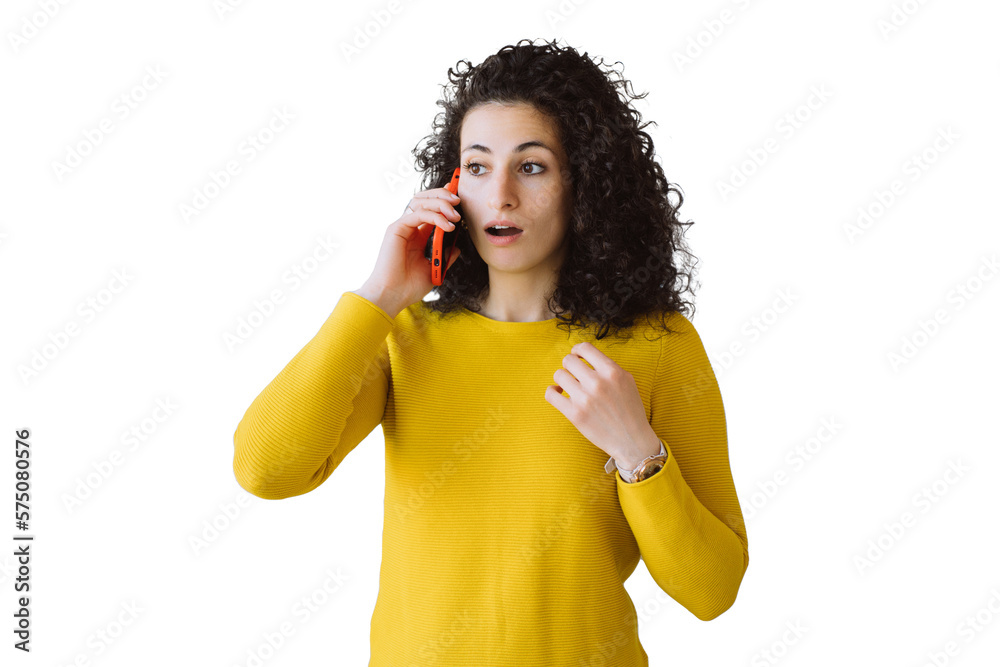 Surprised young Italian curly woman in yellow sweater talking by phone, received bad news stares aside with opened eyes and mouth. Spanish holding phone amazed housewife against transparent background Surprised young Italian curly woman in yellow sweater talking by phone, received bad news stares aside with opened eyes and mouth. Spanish holding phone amazed housewife against transparent background