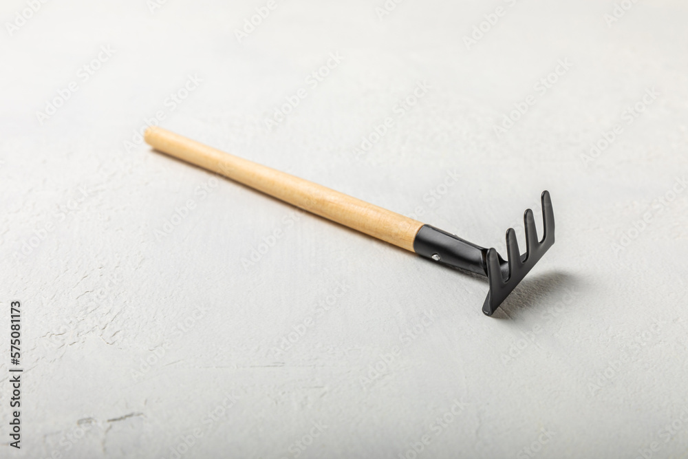 Garden tools on a light concrete background. Space for text. Space for copy. Top view. Gardening concept.Working in the garden.Hobby. Garden rake on a textured background.