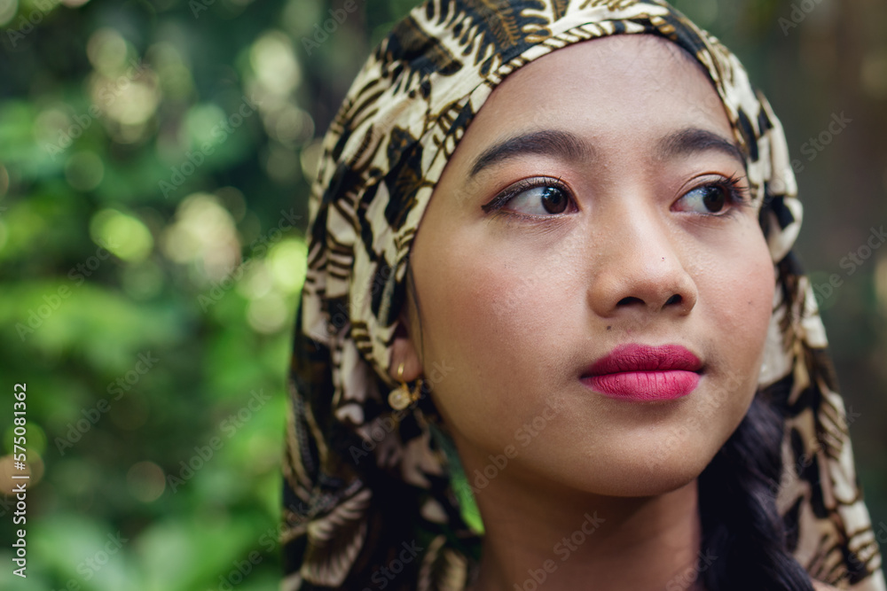Face portrait of young asian girl with scarf head holds Face portrait of young asian girl with scarf head holds