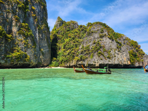 Tourist boats in the blue lagoon on Maya Bai island in Thailand
