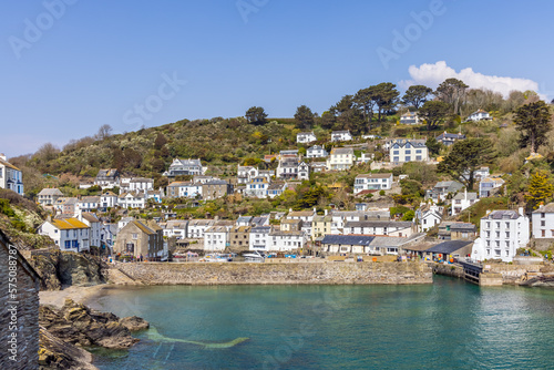 The fishing village of Polperro, with its harbour wall and narrow entrance to the inner harbour. Polperro is a charming and picturesque fishing village in south east Cornwall. photo