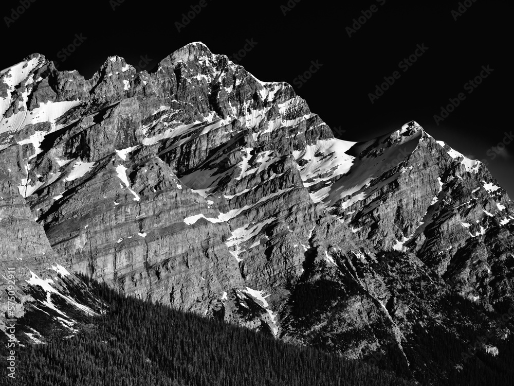 Striking Black and White image of the rugged and majestic glacier formed and sculpted mountains of the Canadian Rockies in Jasper Alberta