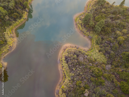 High-angle views taken from a drone of Lake Hollywood, or Hollywood Reservoir, in the Hollywood neighborhood of Los Angeles, California. Pictures taken after a large rainfall showing the lush foliage.