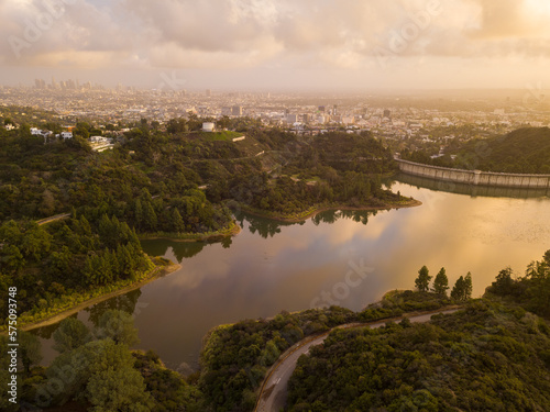 High-angle views taken from a drone of Lake Hollywood, or Hollywood Reservoir, in the Hollywood neighborhood of Los Angeles, California. Pictures taken after a large rainfall showing the lush foliage.