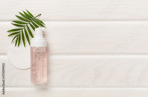 Wallpaper Mural Foaming facial cleanser and with eco pads on wooden background, top view Torontodigital.ca