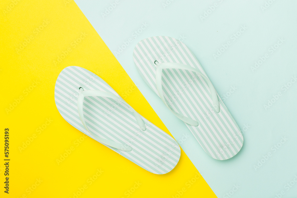 Striped flip flops on color background, top view Striped flip flops on color background, top view