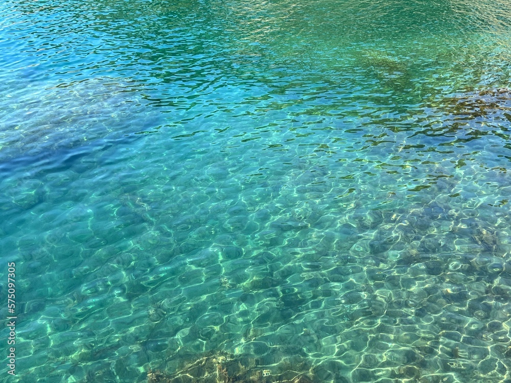 Clear sea healing water with transparent glittering surface.