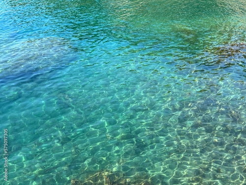 Clear sea healing water with transparent glittering surface.