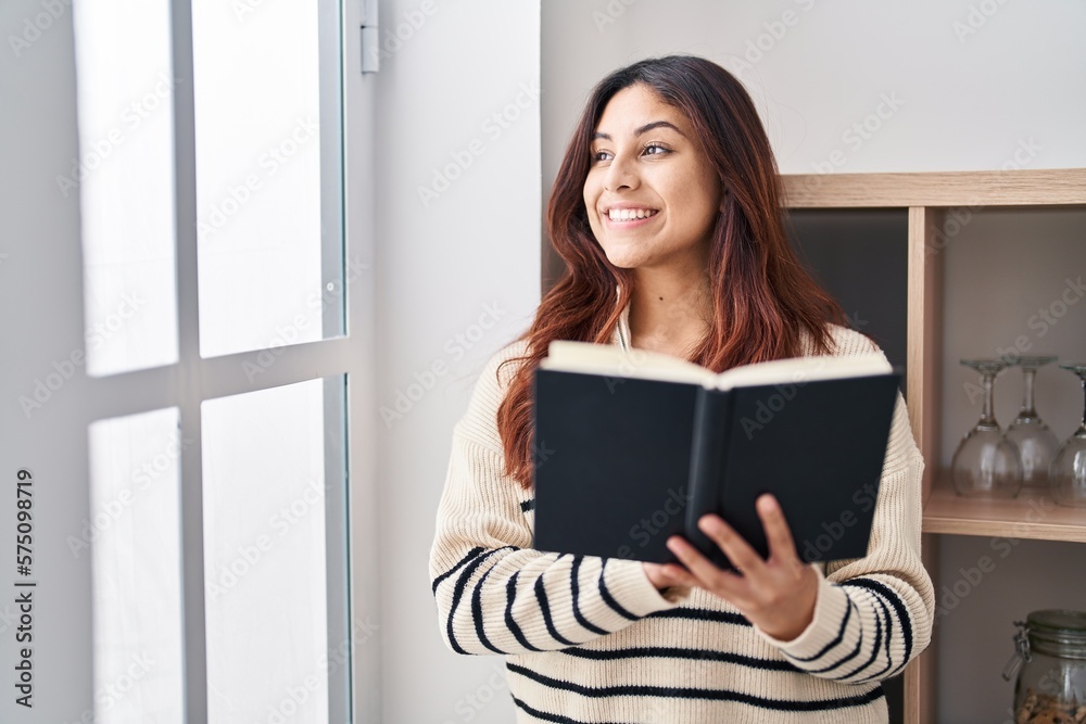 Young hispanic woman smiling confident reading book at home Young hispanic woman smiling confident reading book at home