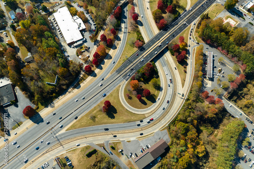 Aerial view of american freeway intersection with fast moving cars and trucks. USA transportation infrastructure concept